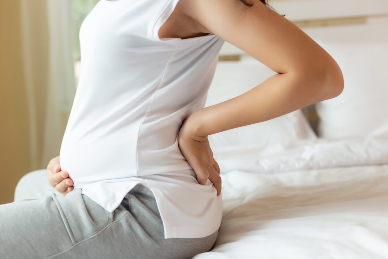 Struggling with back pain during pregnancy? Get tips from a doctor on how to relieve back pain.